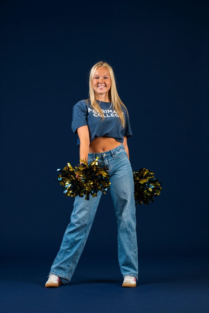 Dancer smiling in clean, fitted outfit for media day headshot