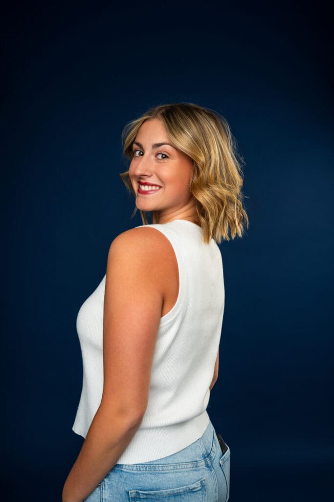 Dancer smiling in clean, fitted outfit for media day headshot