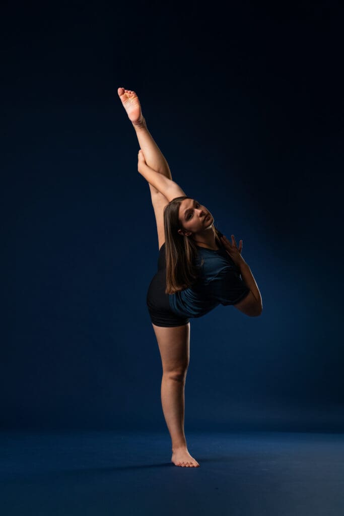Ballet dancer stretching before media day photo session.